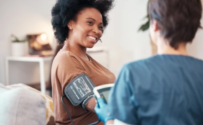 Smiling Black woman having comfortable health checkup with healthcare provider